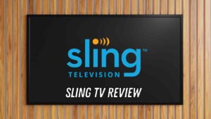 A television screen displaying the Sling TV logo with the words 'Sling TV Review' below it against a wooden background.