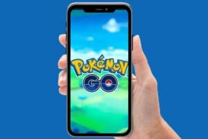 Closeup of a hand holding a smartphone displaying the Pokémon Go logo, ready to turn your neighborhood into a virtual safari zone—Pikachu and pals are lurking out there, so watch your step!