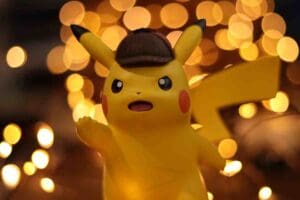 A toy Pikachu, wearing a detective hat, surrounded by glowing bokeh lights, looking like it's ready to solve the mystery of where all those lost socks go. If you named your kid 'Pika Pika', no judgments here!