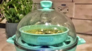 Eggciting meme featuring a tiny pastel blue egg steamer that's about to revolutionize breakfast—unless it decides to have a meltdown first!