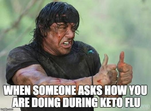 keto flu meme Meme of a rugged man struggling to give a thumbsup with the text: 'When someone asks how you are doing during keto flu,' humorously depicting the struggle of the keto diet side effects.