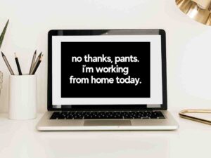 Meme on a laptop screen saying "no thanks, pants. i'm working from home today." amidst a workspace, highlighting remote work humor.