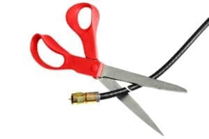 a pair of scissor cutting a cord.