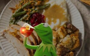 Kermit the Frog sipping tea in front of a delicious Thanksgiving dinner; because sometimes even Kermit needs a plan to get through Monday, one gravyladen bite at a time. #MondayMeme