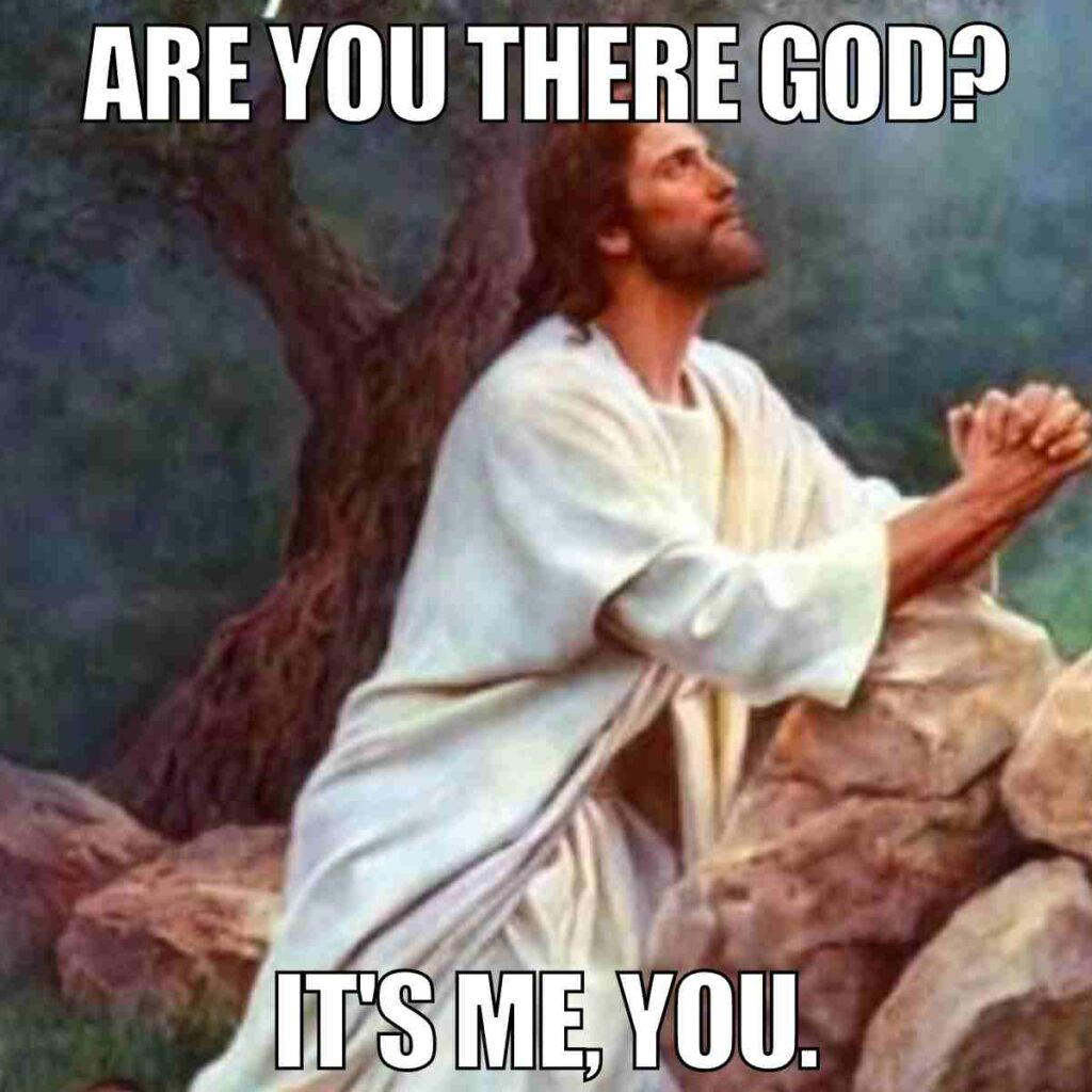 god meme A man with long hair and a beard, dressed in a white robe, kneels with clasped hands in a prayerful pose surrounded by rocks and trees, with the text "ARE YOU THERE GOD? IT'S ME, YOU." overlaid on the image.