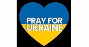 Meme featuring a large heart colored blue and yellow, bearing the message 'Pray for Ukraine,' highlighting solidarity with Ukraine.