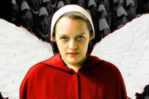 A handmaid in a red cloak and white bonnet stands in front of a backdrop featuring a group of similarly dressed figures in grayscale. The person has large white wings.