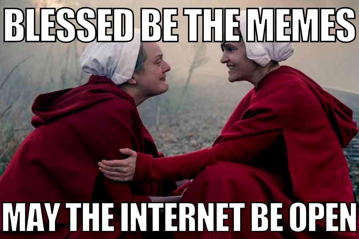 handmaids tale memes a Handmaid's Tale meme showing two women in red cloaks with white bonnets from 'The Handmaid's Tale,' captioned 'Blessed be the memes, may the internet be open,' playfully referencing the show's themes and internet culture.