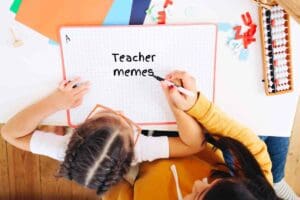 Bird's eye view of a child and an adult, humorously illustrating 'teacher memes' on a whiteboard, hinting at the depths of classroom shenanigans.