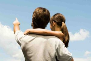 A dad is pointing at the sky, promising his daughter a unicorn farm, while she skeptically wonders if it's just a dad joke in meme format.