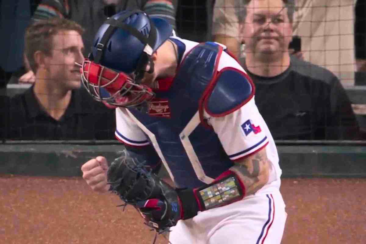 Jonah Heim meme texas rangers Texas baseball player in celebratory pose with fist in the air, sporting Texas flag patch and protective gear, embodying "Yeehaw! I caught it!" meme vibe.
