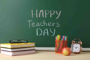 Meme with a chalkboard that says 'Happy Teacher's Day' alongside a classic alarm clock, stack of books, apple, and a chaos of pens, because every teacher needs caffeine and serenity, right?