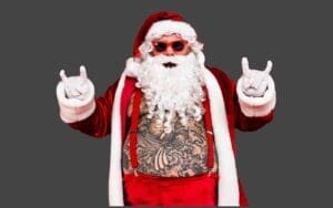 Santa Claus showing off his rockstar side with tattoos peeking out, wearing cool shades and throwing up the horns—Christmas meme vibes at their coolest.
