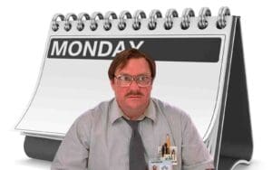 Meme of an office worker with glasses and pens in his pocket, looking unimpressed, in front of a giant Monday calendar page.