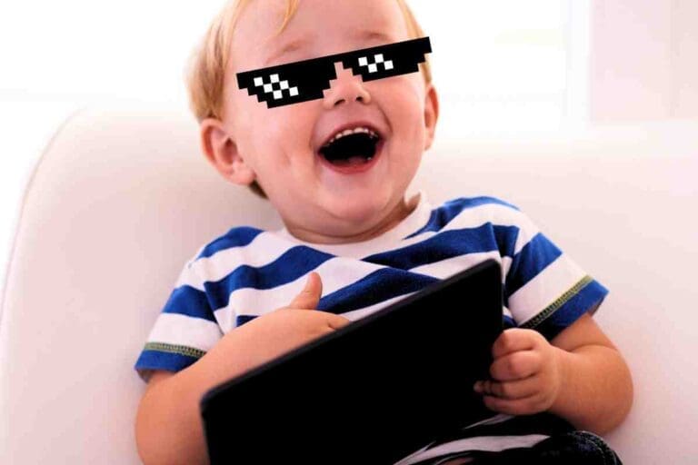 A meme featuring a joyful toddler wearing pixelated sunglasses, holding a tablet and sporting a mischievous grin like he's just become the CEO of adorable antics.