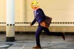Meme of a person in a suit with an emoji face, resembling an "Oh no, I'm late!" expression, running with a briefcase, capturing the frantic Monday morning hustle to the office.