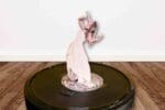 cut out print meme of taylor swift on top of roomba robotic vacuum from whos afraid of little old me eras tour performance