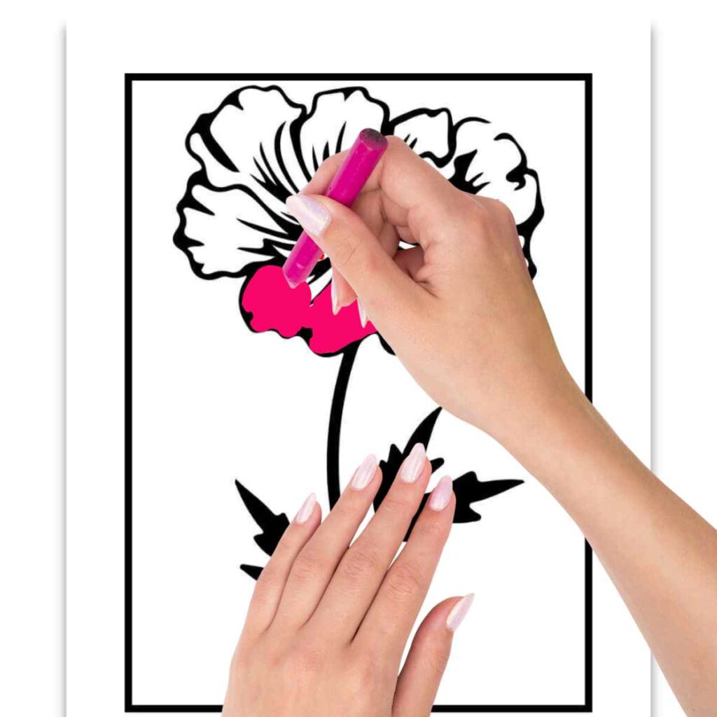 coloring of flowers A person's hands coloring a flower outline with a pink marker on a sheet of paper.