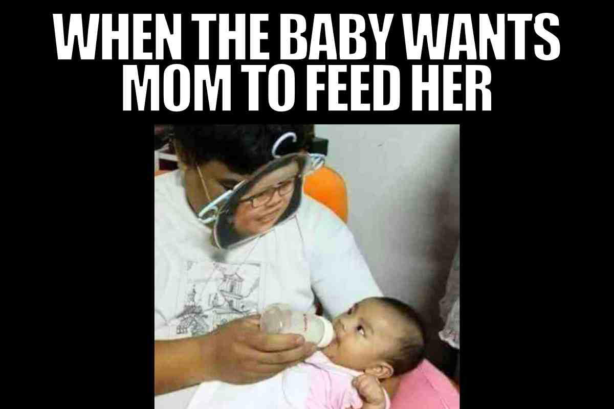 feeding baby meme A feeding baby memes showing a person wearing a face mask with a printed image, feeding a baby with a bottle, under text reading "WHEN THE BABY WANTS MOM TO FEED HER."
