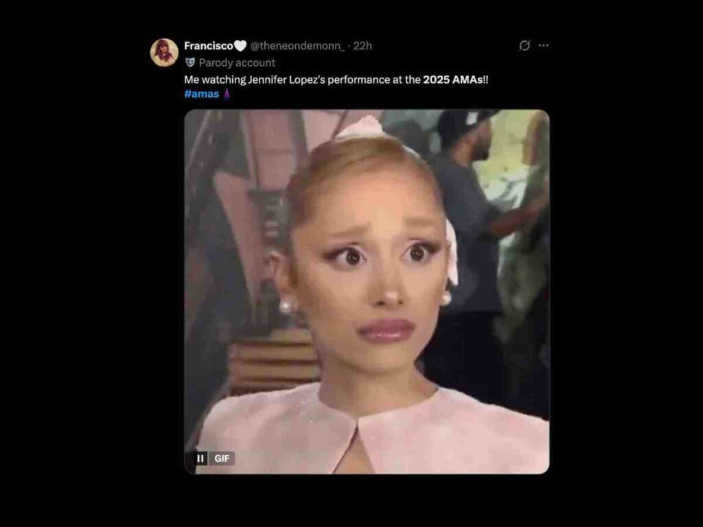 2025 ama jennifer lopez meme A person with wide eyes and a surprised expression, wearing a light pink outfit and a bow in their hair, set against a blurred background on a social media post discussing the 2025 AMAs performance.